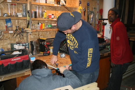 Helping make chair dollies in their wood shop