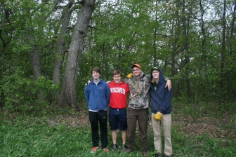 MUHS students Max Neimon, Jacob Baisden, Owen Byrne, and Sebastian Pruhs standing proudly in front of the opened up woodland
