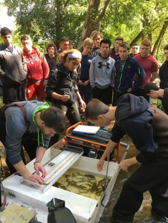College students teaching MUHS students about fish monitoring