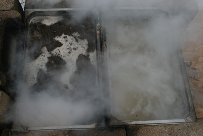 Boiling off the Sap. On the left is the concentrated syrup, Right is the Sap