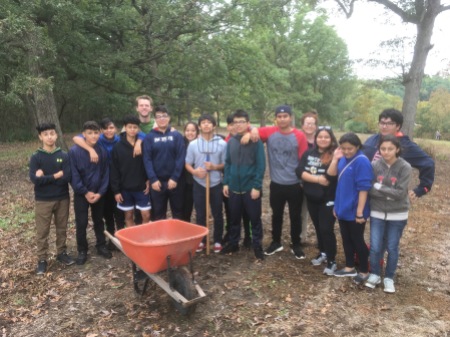 Cristo Rey High School students helping seed the prairie (and mulch a nature trail)